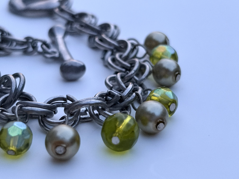 Silver tone chain link charm bracelet with green faceted beads and faux pearls